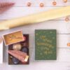 happy birthday greeting card beside pink and gold baubles