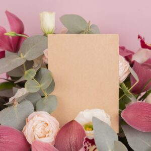 pink and white roses beside pink and white card