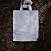 Photo by luciano paris white paper bag on brown grass