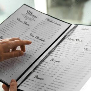 Woman reading menu in cafe, closeup